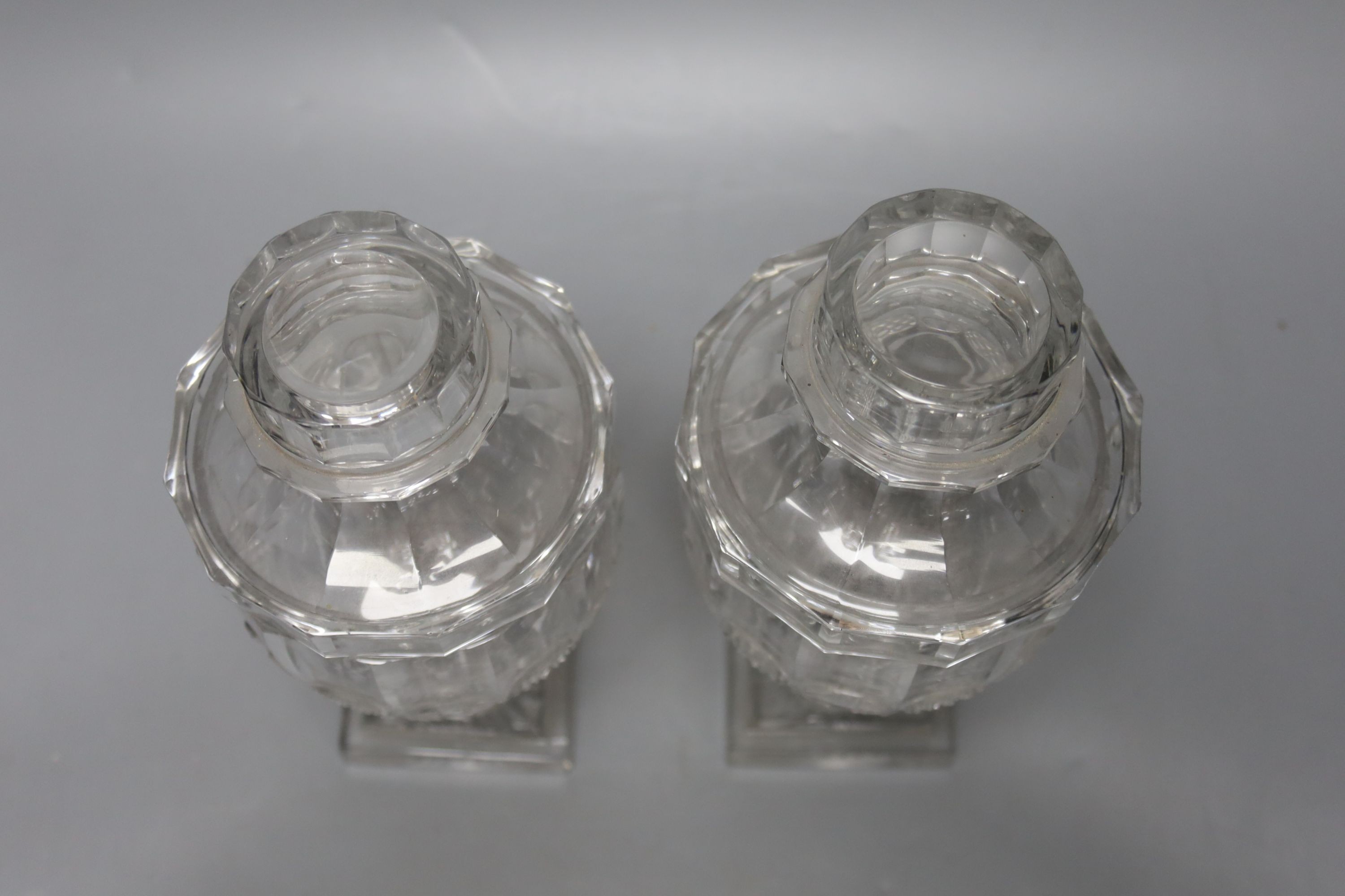 A pair of Victorian cut glass urns and covers